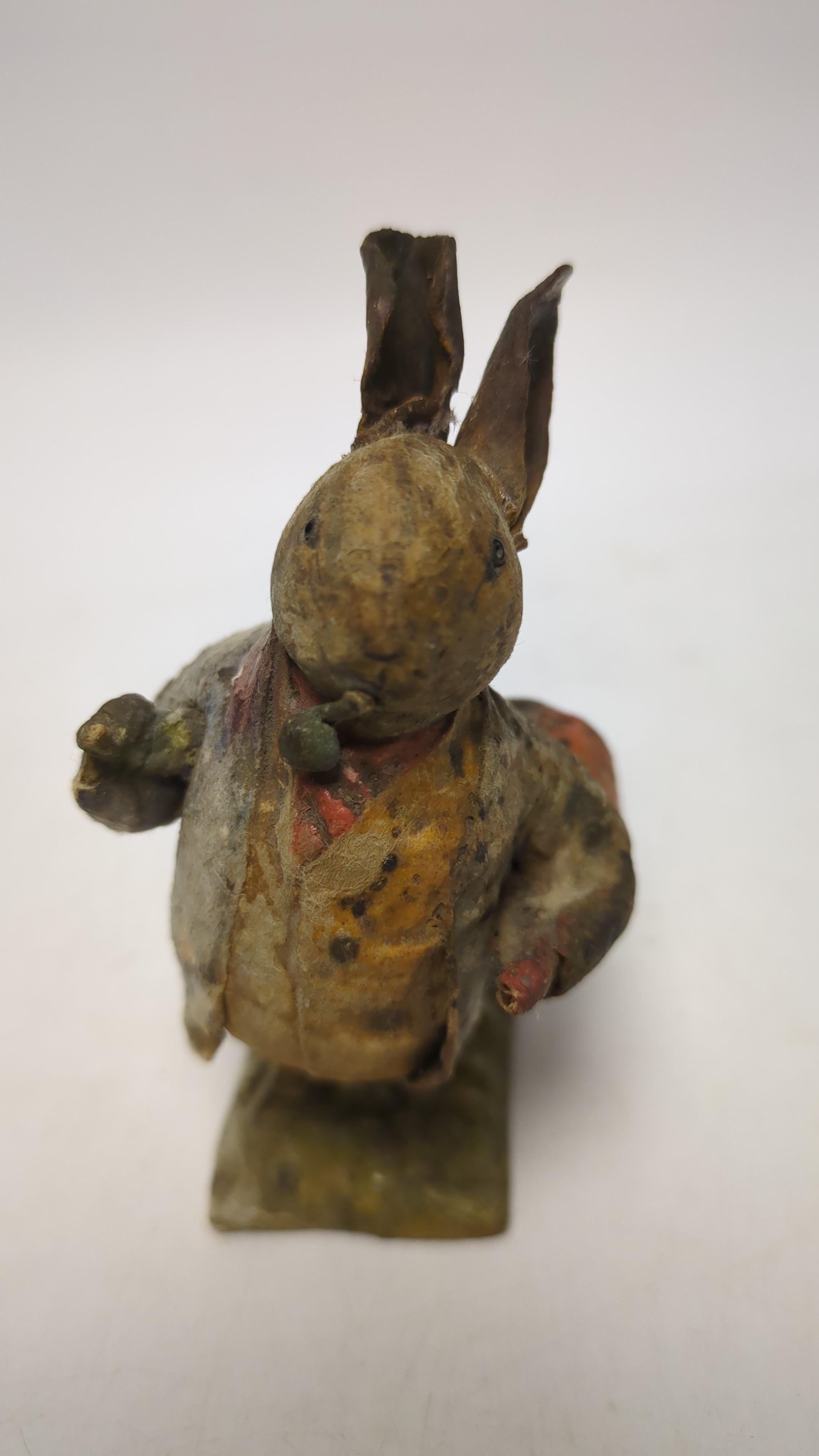 An F. Warne papier-mâché Beatrix Potter figure of Benjamin Bunny with pipe and red handkerchief bag, red and white F. Warne & Co. paper label to the base, dating it to pre-1917, 9cm high